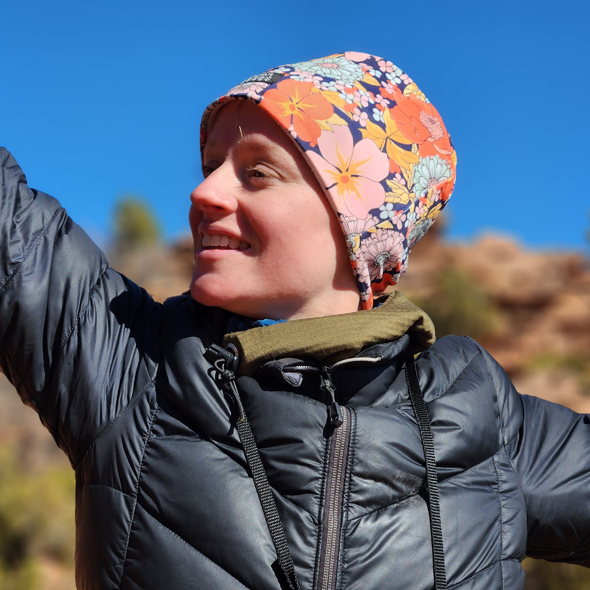 A brightly lit starlet in a pink hat looks into the distance where she is sure to find adventure